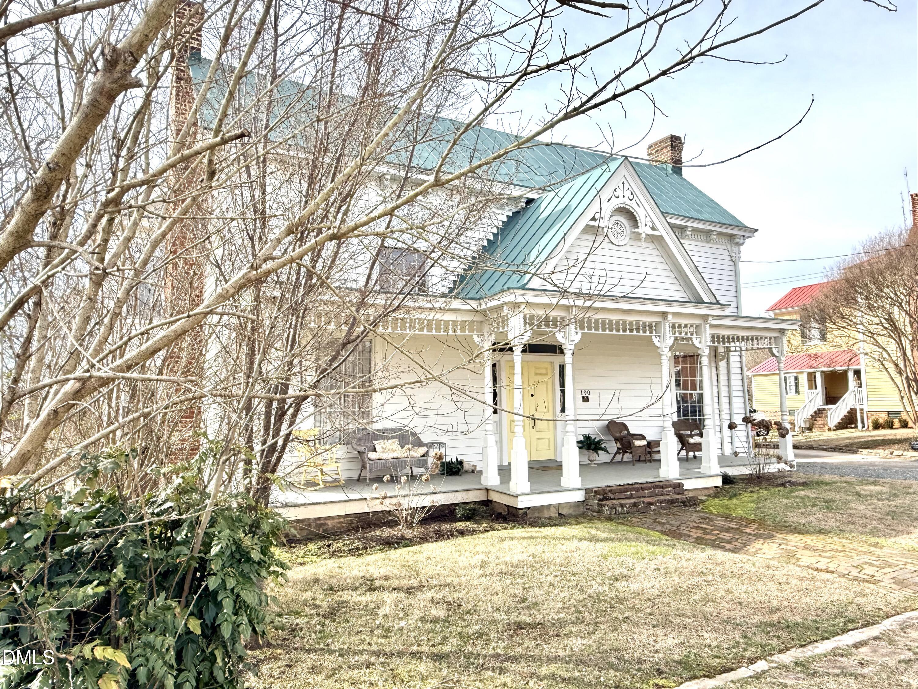 190 Broad Street Milton, NC 27305 - Photo 54 of 62 a view of a white house with a large tree and a yard
