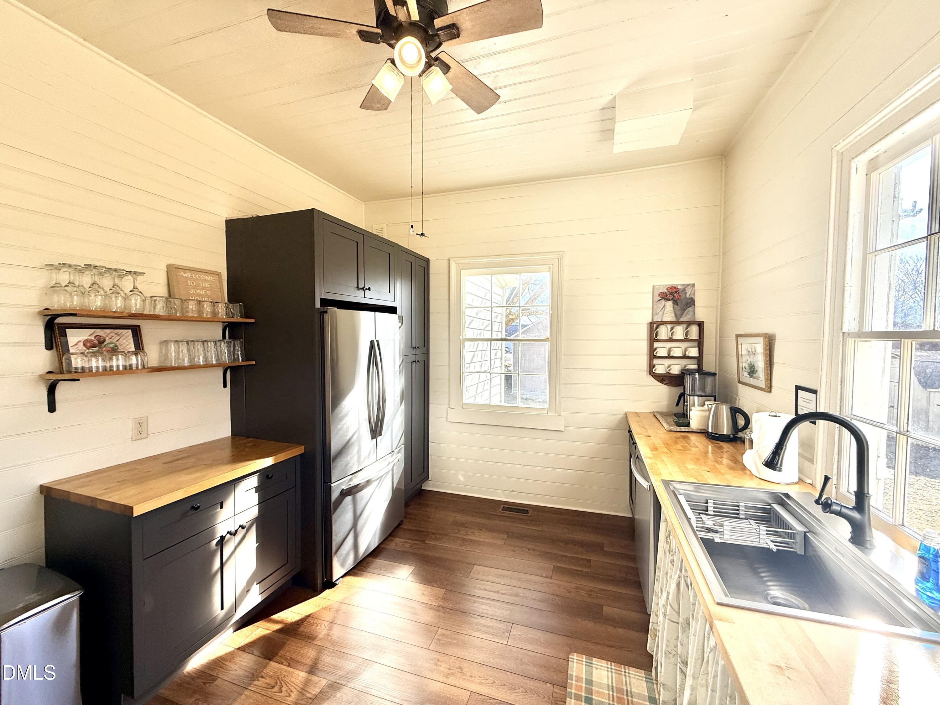 190 Broad Street Milton, NC 27305 - Photo 9 of 62 a kitchen with stainless steel appliances granite countertop a refrigerator a sink a stove and island with wooden floor