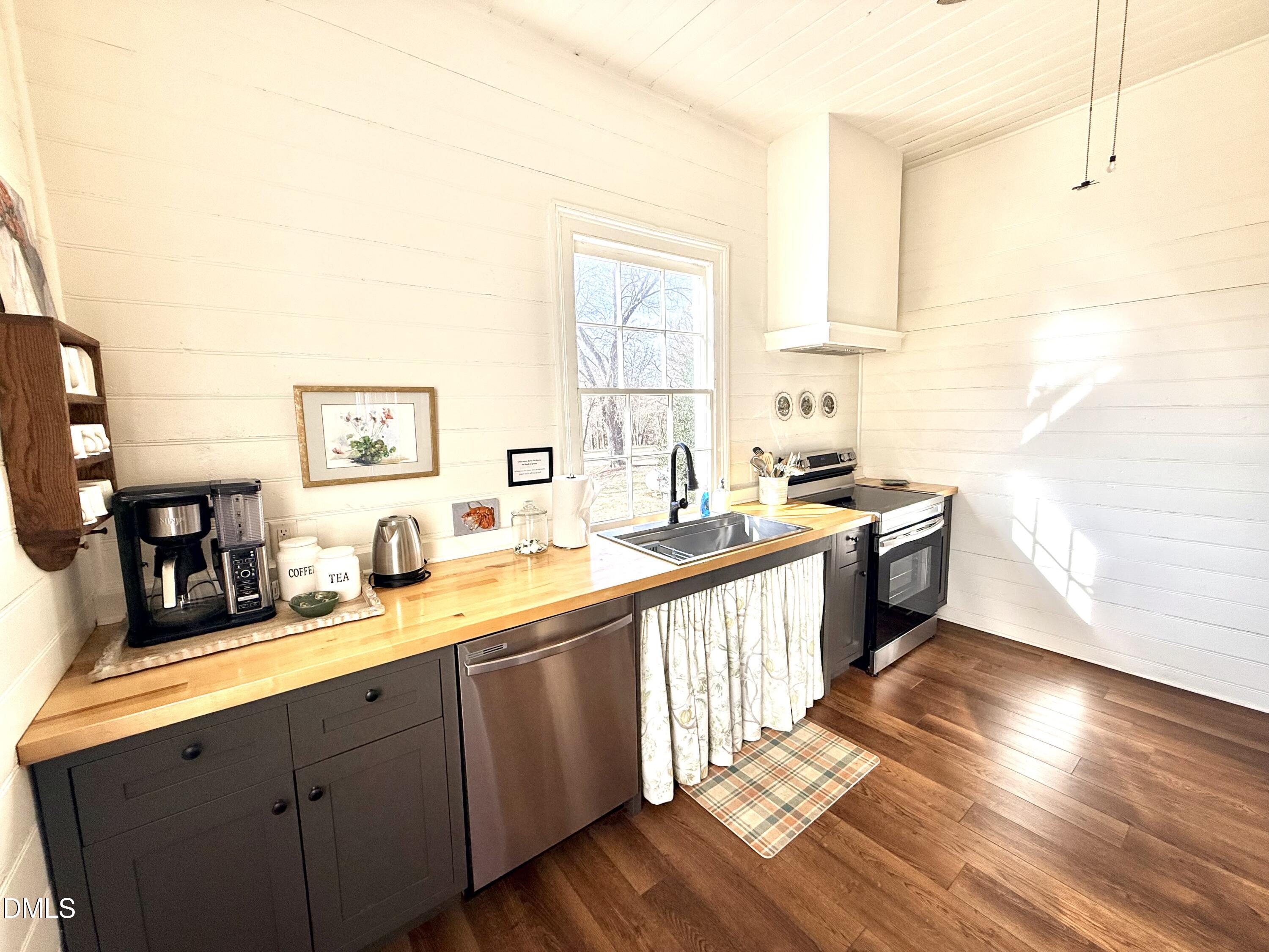 190 Broad Street Milton, NC 27305 - Photo 10 of 62 a large kitchen with a lot of counter space and wooden floor