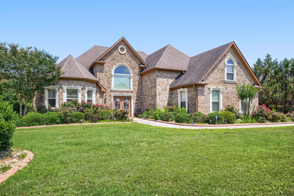 345 Masters Club Boulevard Hampton, GA 30228 - Photo 2 of 30 a front view of a house with a yard