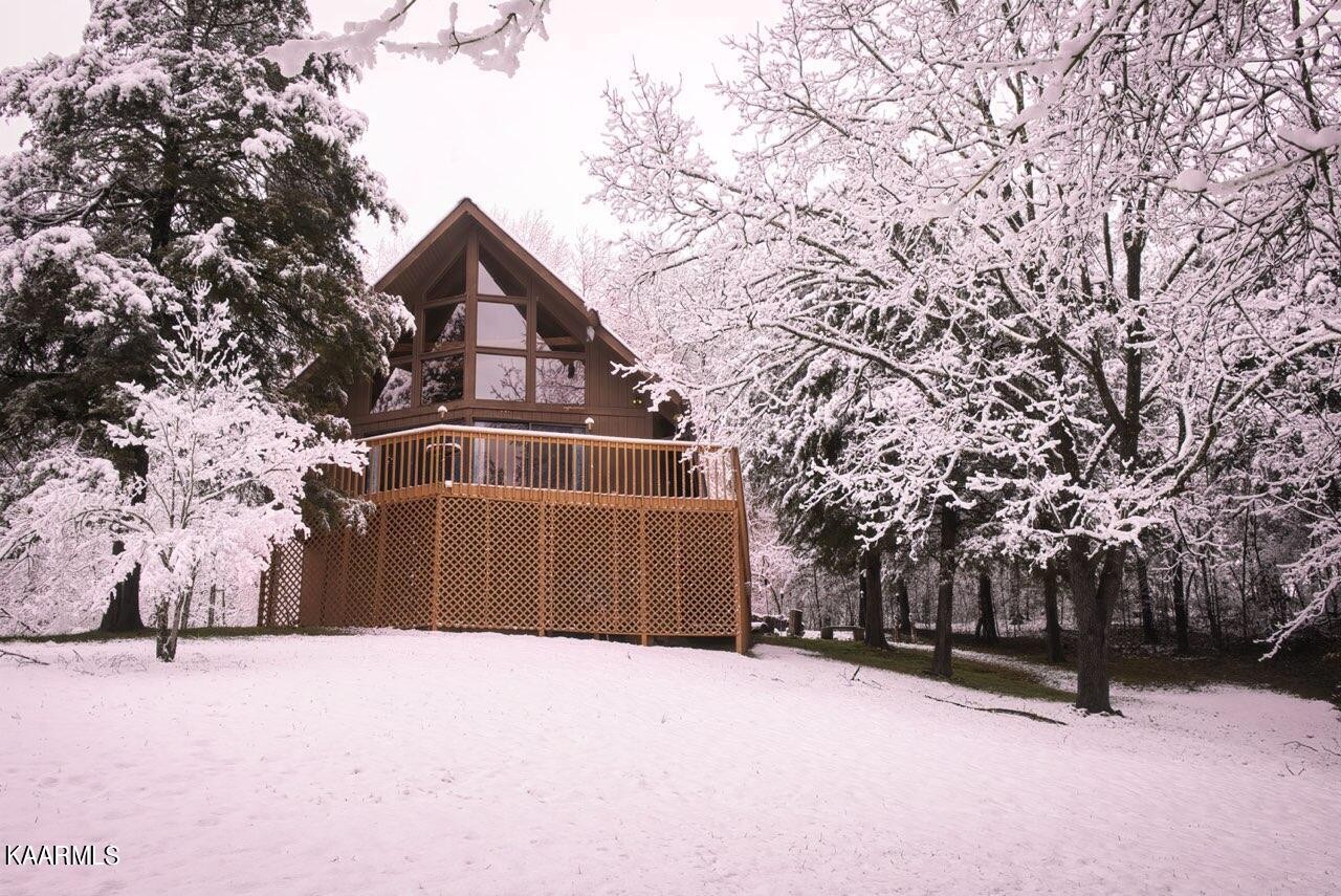 2356 Black Oak Ridge Road Sevierville, TN 37876 - Photo 2 of 33 a front view of a house with a yard covered in snow