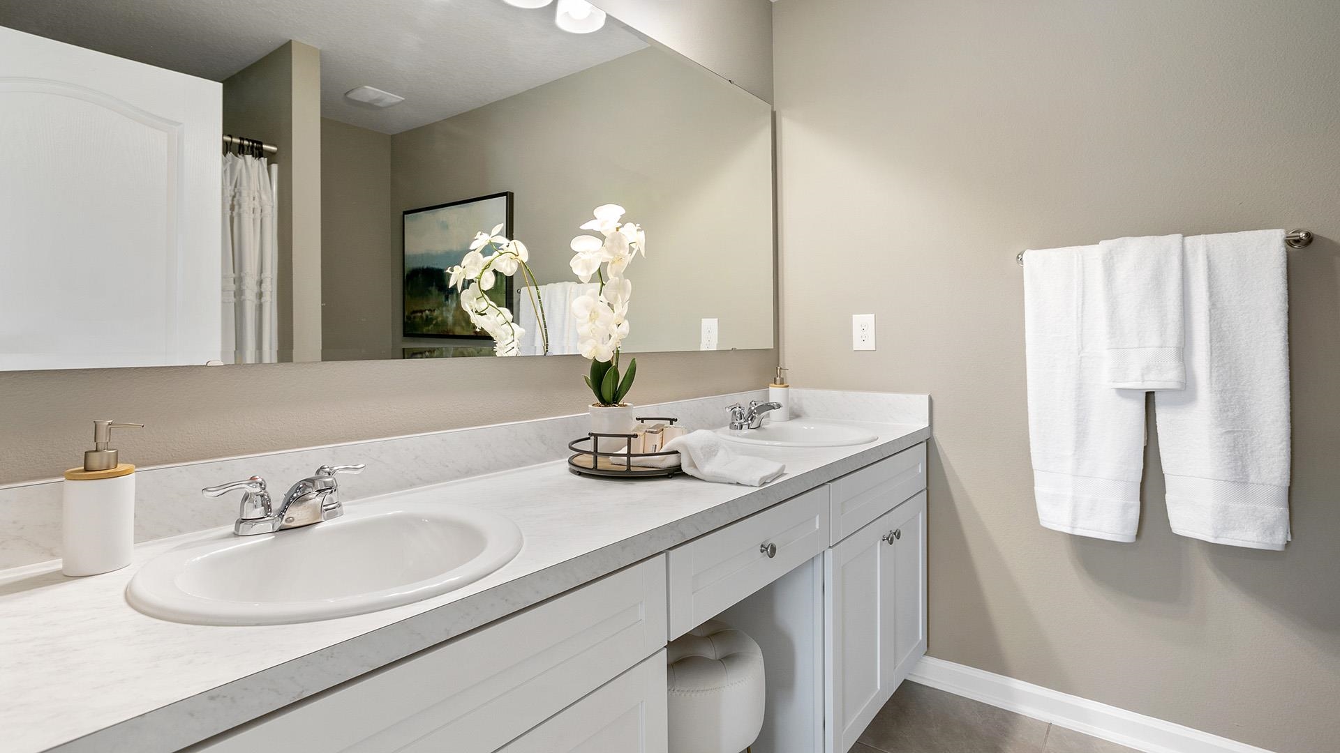 483 Redbud Road Palm Coast, FL 32137 - Photo 13 of 32 a bathroom with a double vanity sink and a mirror