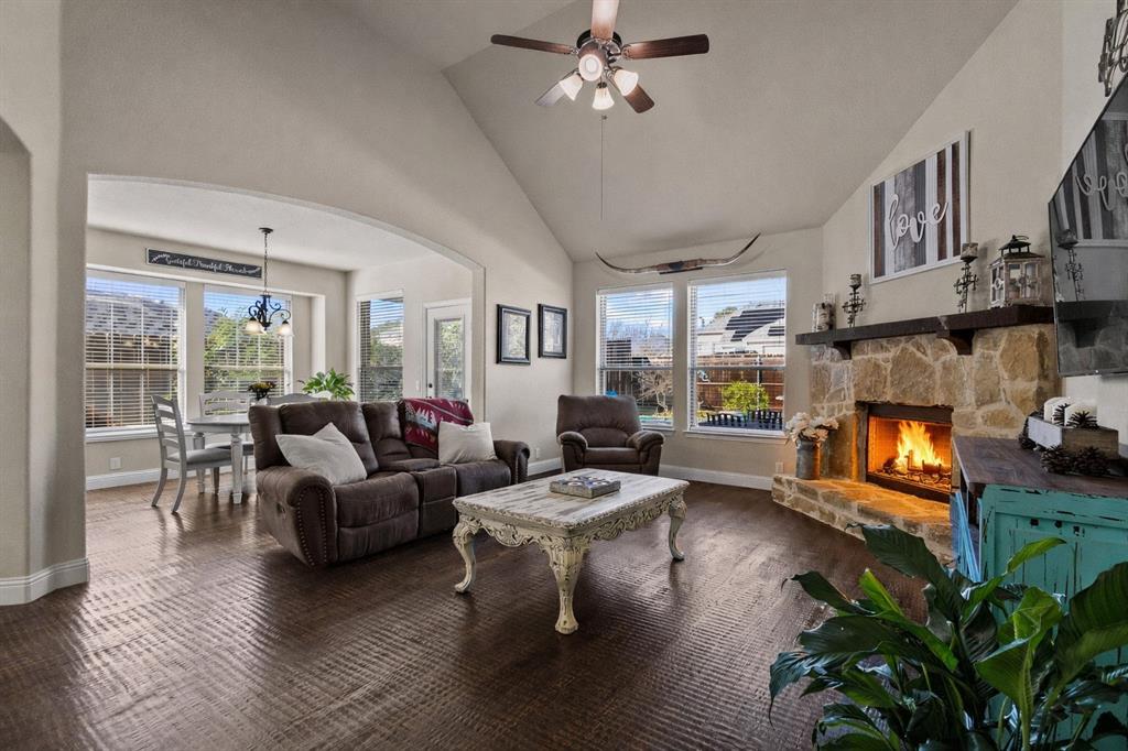 320 Sherbrook Street Van Alstyne, TX 75495 - Photo 11 of 38 High ceilings, venetian bronze ceiling fan, wood burning fireplace with cedar mantle