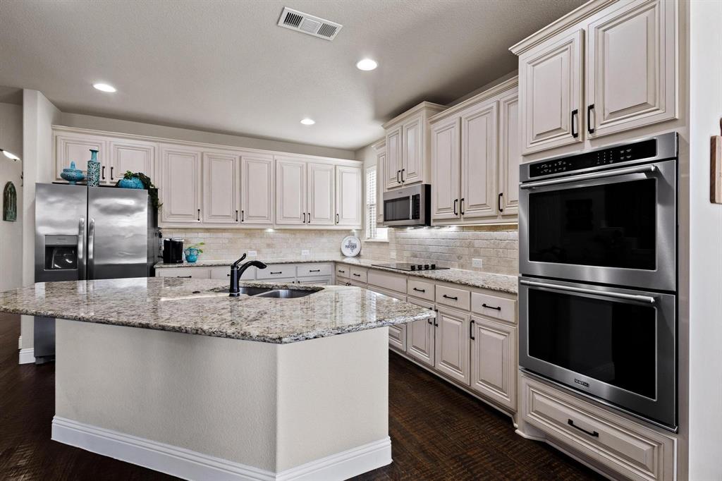 320 Sherbrook Street Van Alstyne, TX 75495 - Photo 7 of 38 Double Ovens for all those entertaining events. 2.0 cu ft microwave, 42 inch maple cabinets with adjustable shelves and hidden hinges.