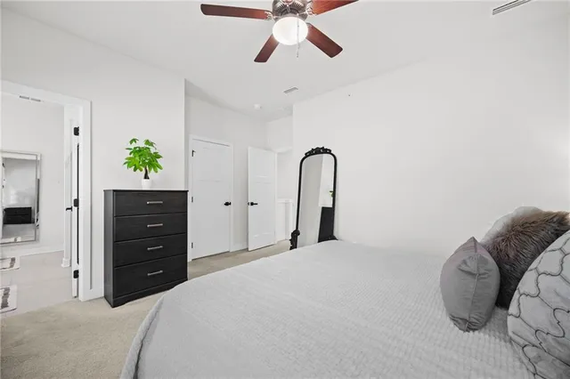 a bedroom with a bed and a dresser