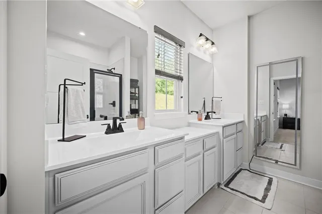 a bathroom with a double vanity sink mirror and double