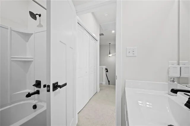 a bathroom with a tub a sink and a shower