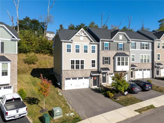a front view of a residential houses with yard