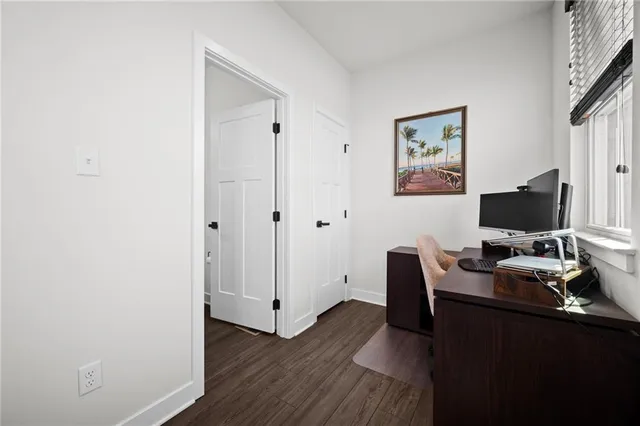 a view of a workspace with furniture and wooden floor