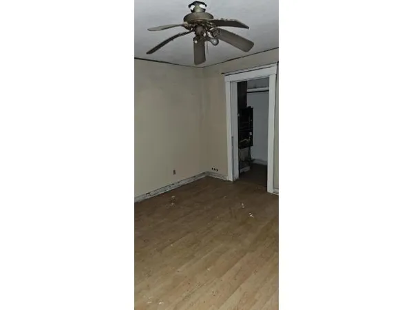 a view of a room with a ceiling fan