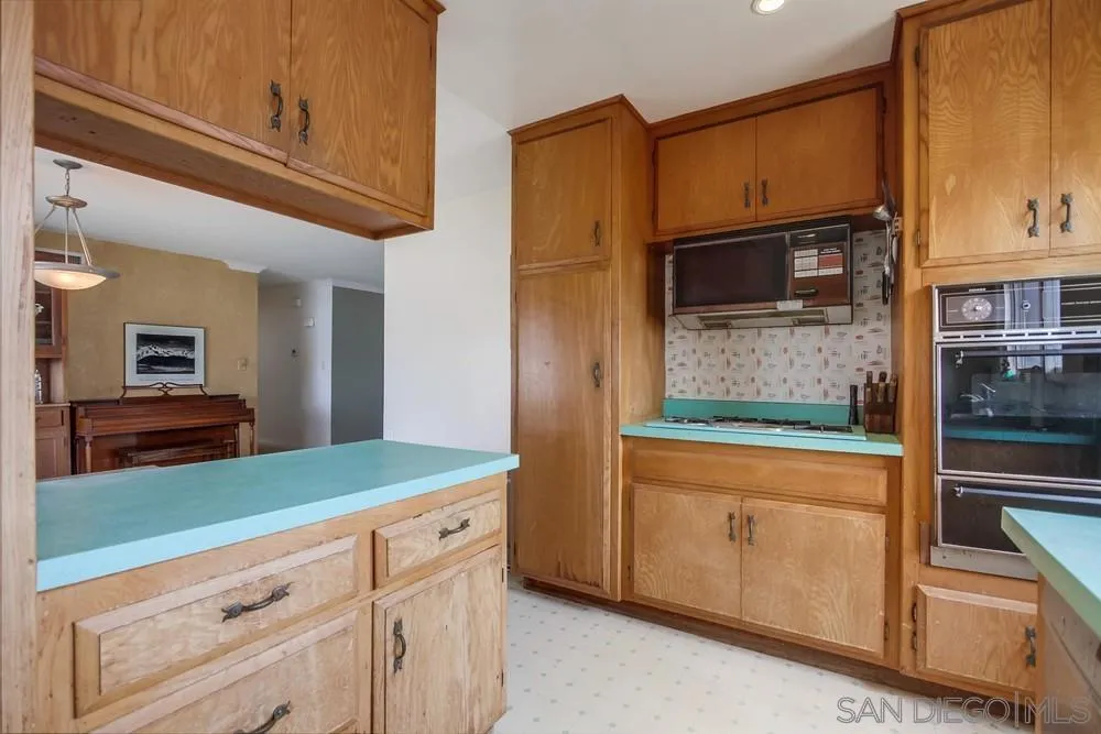 1800 Guevara Road Carlsbad, CA 92008 - Photo 13 of 29 a kitchen with stainless steel appliances granite countertop a refrigerator and cabinets