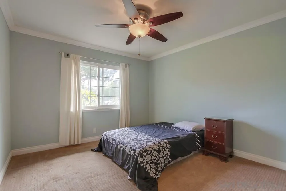 1800 Guevara Road Carlsbad, CA 92008 - Photo 17 of 29 a bedroom with a bed and a ceiling fan