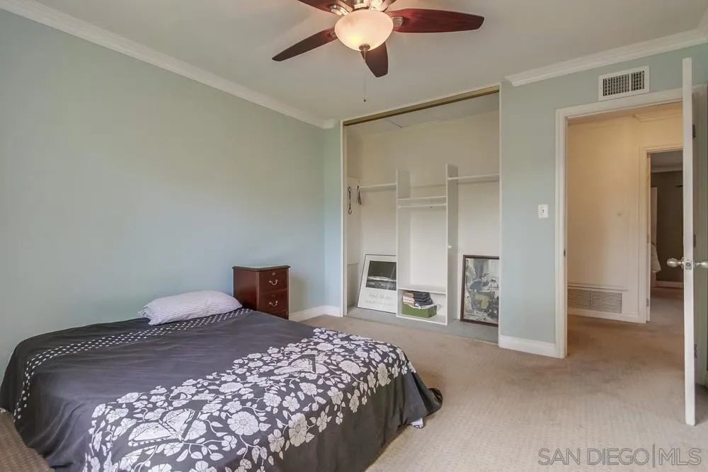 1800 Guevara Road Carlsbad, CA 92008 - Photo 18 of 29 a bedroom with a large bed and a chandelier