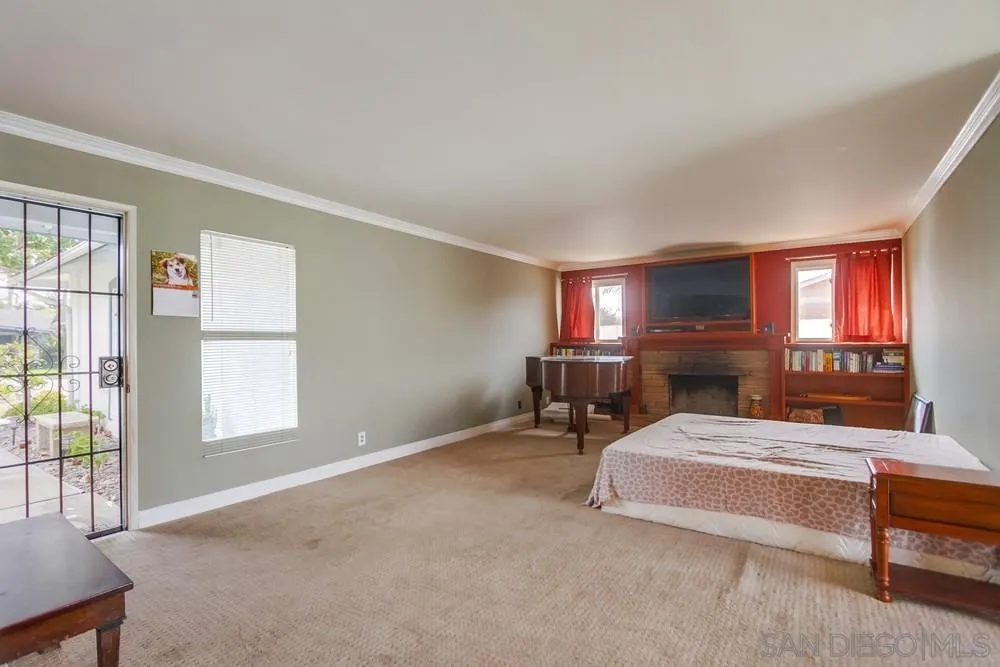 1800 Guevara Road Carlsbad, CA 92008 - Photo 3 of 29 a living room with furniture a flat screen tv and a window