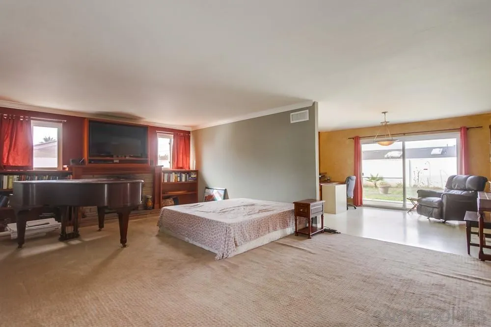 1800 Guevara Road Carlsbad, CA 92008 - Photo 4 of 29 a bedroom with a bed and large windows