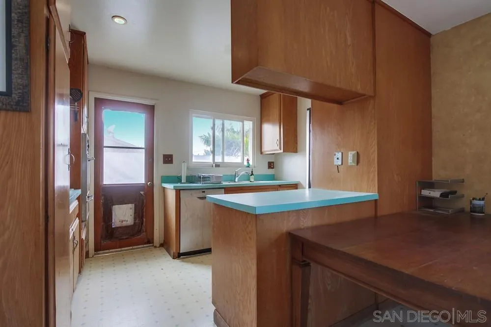 1800 Guevara Road Carlsbad, CA 92008 - Photo 8 of 29 a kitchen with stainless steel appliances granite countertop a sink and a refrigerator