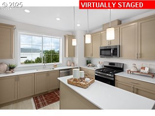 16658 Southwest Jean Louise Road Tigard, OR 97223 - Photo 15 of 19 a kitchen with kitchen island granite countertop a sink cabinets and window