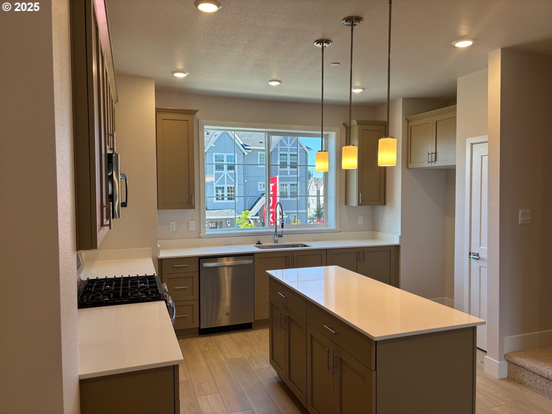 16658 Southwest Jean Louise Road Tigard, OR 97223 - Photo 2 of 19 a kitchen with stainless steel appliances granite countertop a sink a stove a refrigerator and island