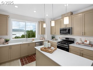 16658 Southwest Jean Louise Road Tigard, OR 97223 - Photo 10 of 19 a kitchen with a stove a sink and a microwave
