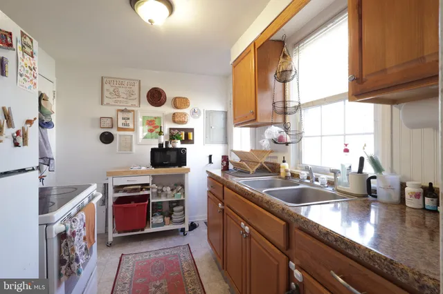 a kitchen with a sink and a stove top oven