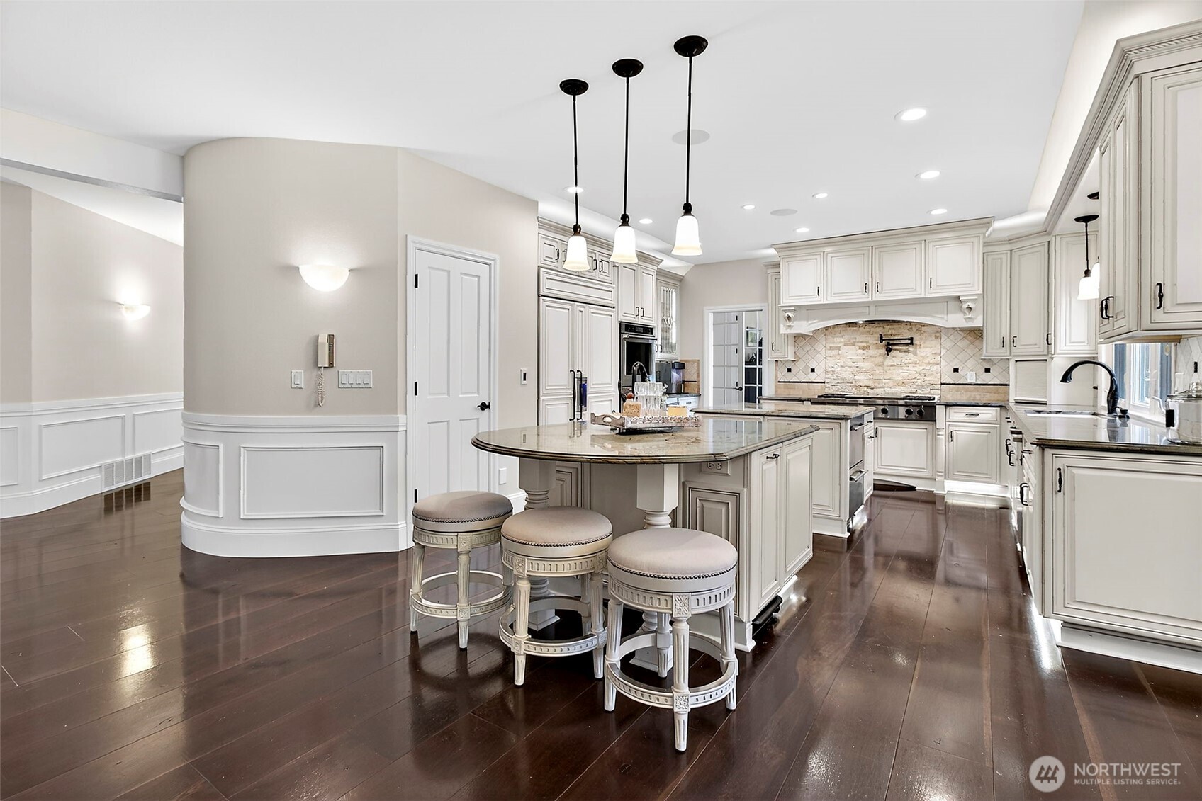 34529 5th Place Southwest Federal Way, WA 98023 - Photo 18 of 40 a kitchen with stainless steel appliances kitchen island granite countertop a dining table chairs and white cabinets
