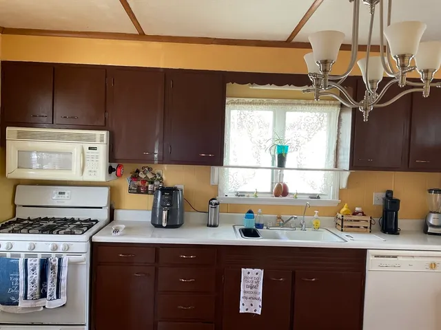 a kitchen with a sink a stove and cabinets