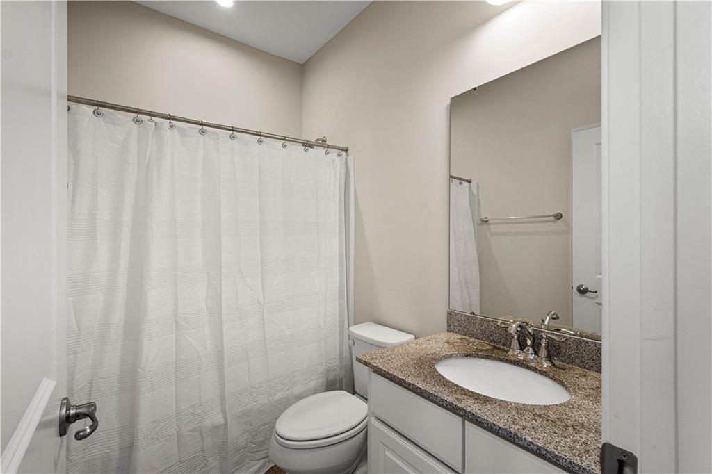 152-160 Cole Drive McKees Rocks, PA 15136 - Photo 28 of 39 a bathroom with a granite countertop sink toilet a mirror and shower