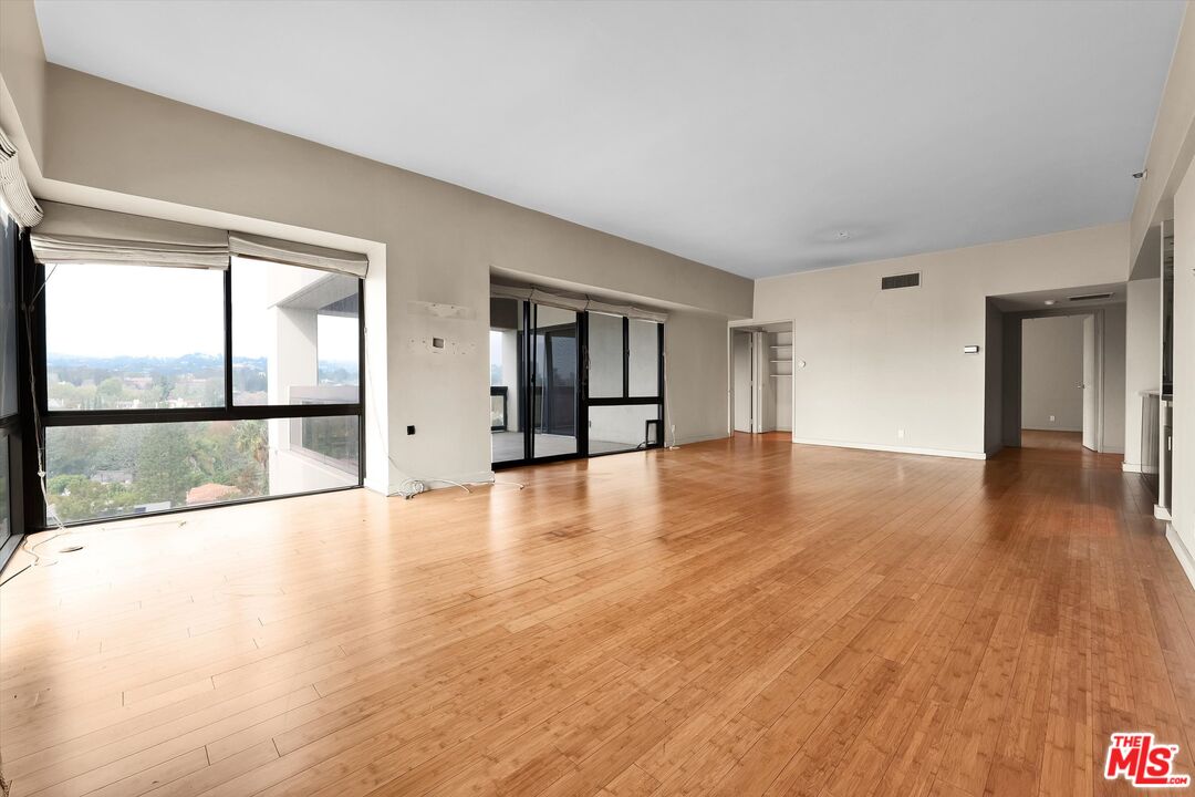 10445 Wilshire Boulevard, Unit 904 Los Angeles, CA 90024 - Photo 12 of 40 wooden floor in an empty room with a window