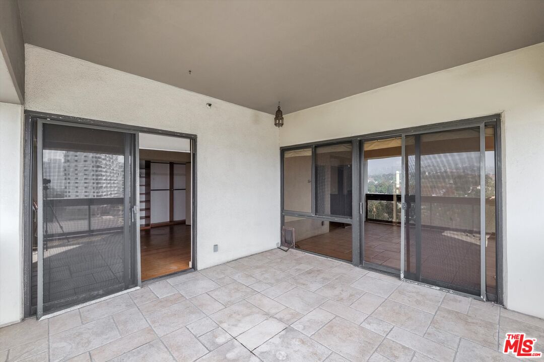 10445 Wilshire Boulevard, Unit 904 Los Angeles, CA 90024 - Photo 15 of 40 an empty room with closet and windows