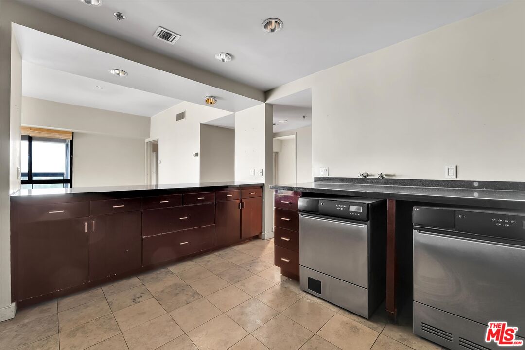10445 Wilshire Boulevard, Unit 904 Los Angeles, CA 90024 - Photo 17 of 40 a kitchen with a stove and a sink
