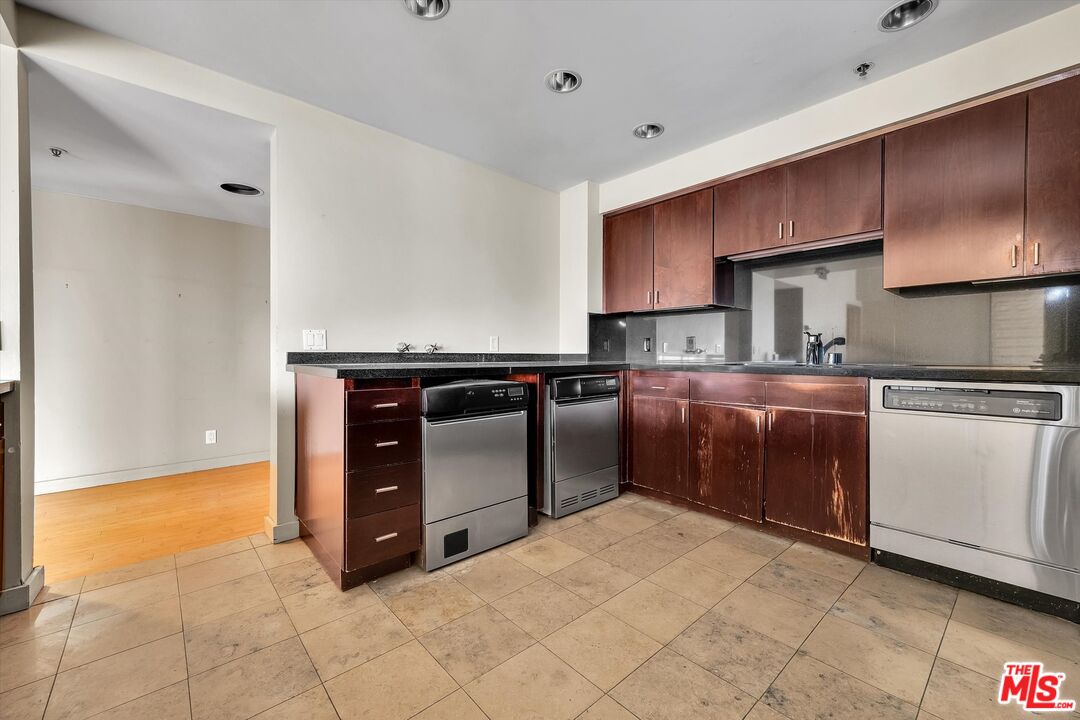 10445 Wilshire Boulevard, Unit 904 Los Angeles, CA 90024 - Photo 18 of 40 a kitchen with stainless steel appliances granite countertop a stove a sink and a refrigerator