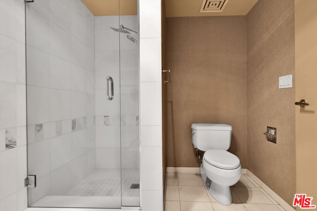 10445 Wilshire Boulevard, Unit 904 Los Angeles, CA 90024 - Photo 24 of 40 a bathroom with a toilet and a shower