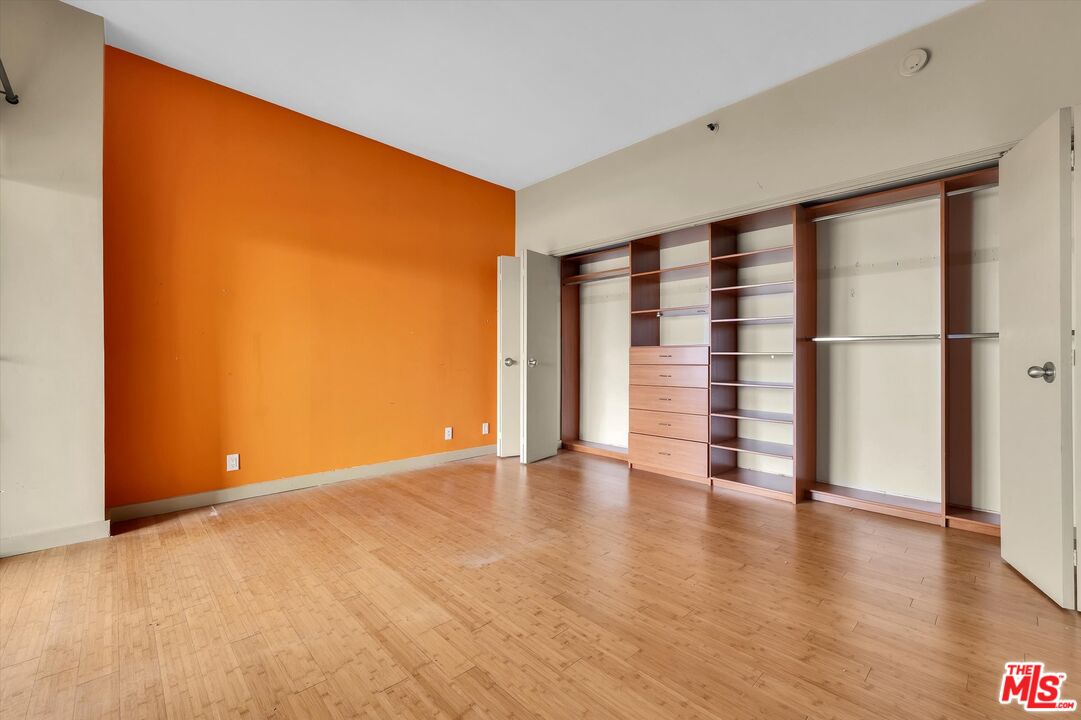 10445 Wilshire Boulevard, Unit 904 Los Angeles, CA 90024 - Photo 27 of 40 a view of an empty room with wooden floor and a window