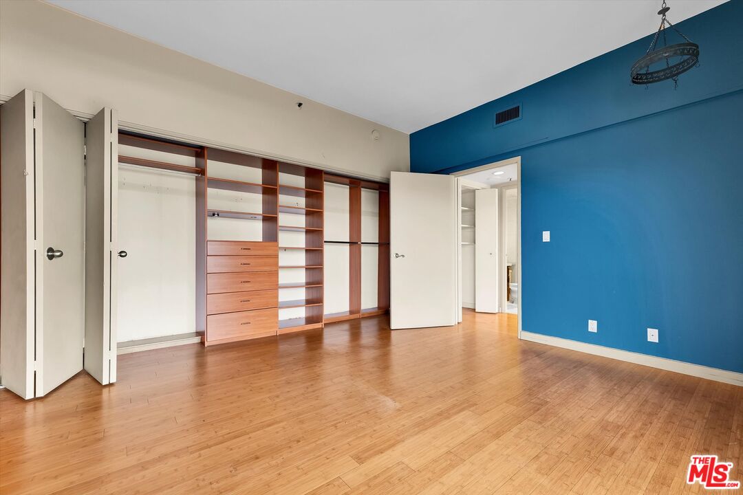 10445 Wilshire Boulevard, Unit 904 Los Angeles, CA 90024 - Photo 29 of 40 a view of an empty room with wooden floor and a window