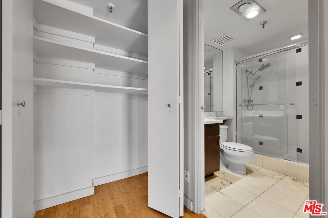 10445 Wilshire Boulevard, Unit 904 Los Angeles, CA 90024 - Photo 30 of 40 a bathroom with a toilet and a shower