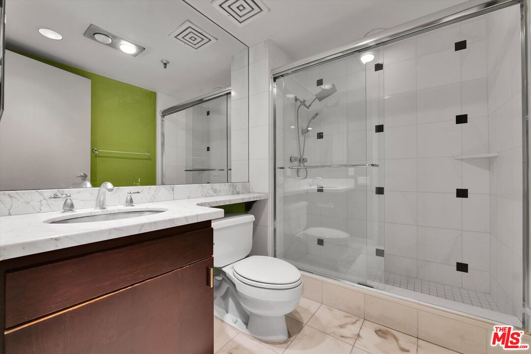 10445 Wilshire Boulevard, Unit 904 Los Angeles, CA 90024 - Photo 31 of 40 a bathroom with a sink a toilet and shower