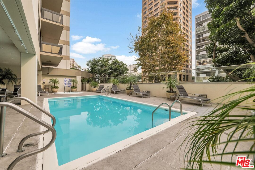 10445 Wilshire Boulevard, Unit 904 Los Angeles, CA 90024 - Photo 32 of 40 a view of swimming pool with outdoor seating and city view