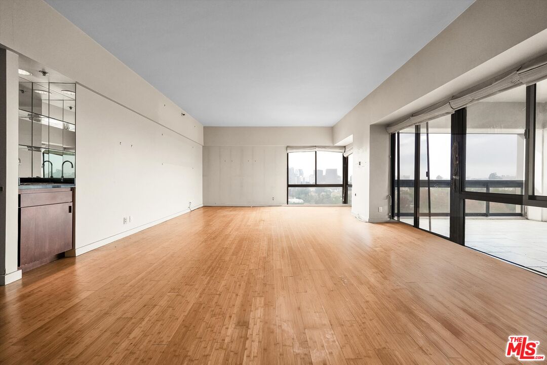 10445 Wilshire Boulevard, Unit 904 Los Angeles, CA 90024 - Photo 7 of 40 wooden floor in an empty room with a window