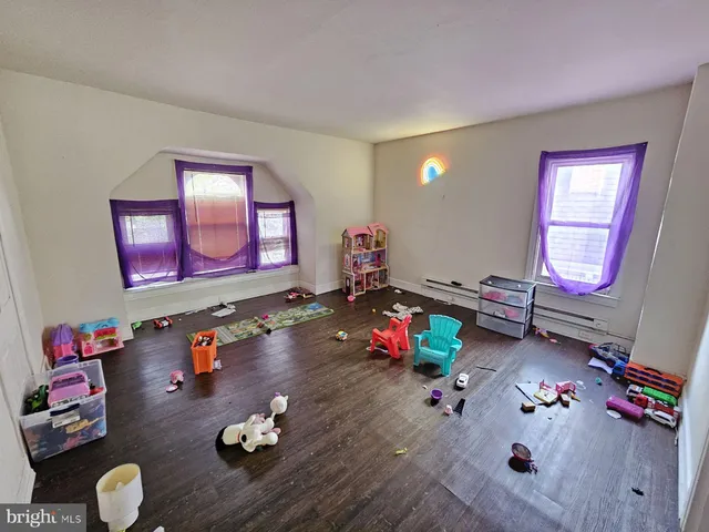 a living room with furniture and next to a window