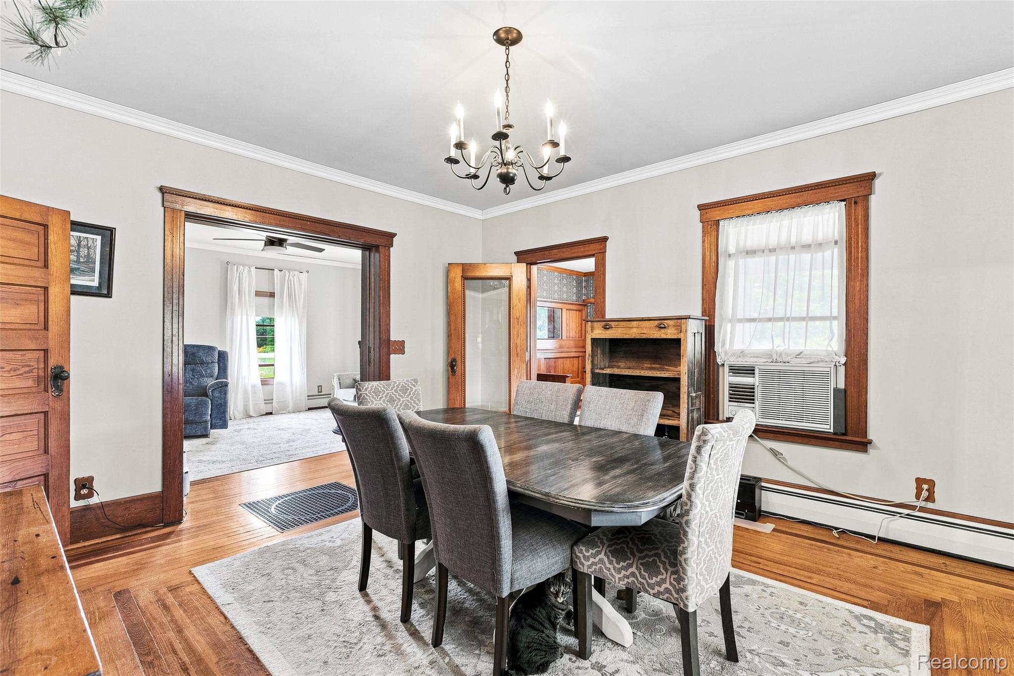 2971 Huron Line Road Cass City, MI 48726 - Photo 14 of 63 Hardwood flooring, crown molding, and a chandelier illuminate this dining area