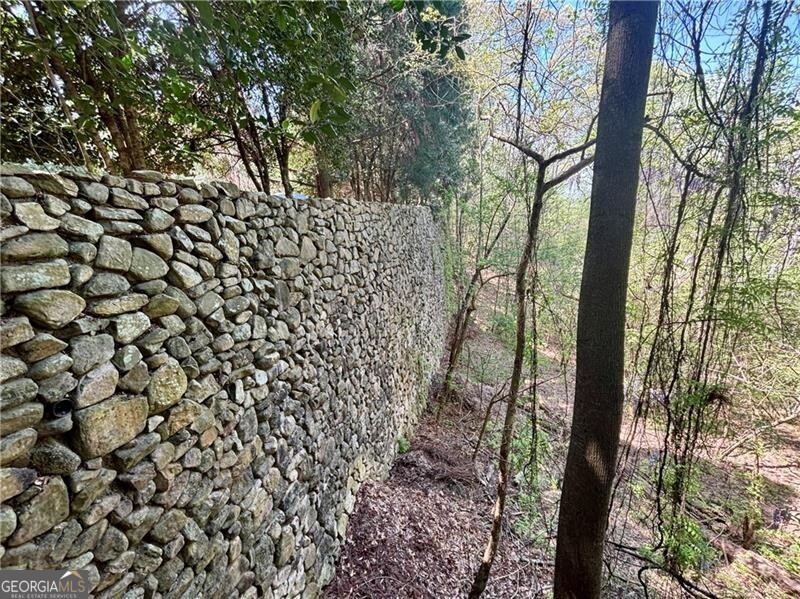2100 West Wesley Road Northwest Atlanta, GA 30327 - Photo 7 of 42 Stunning retaining walls in place, lining 2 sides of the property