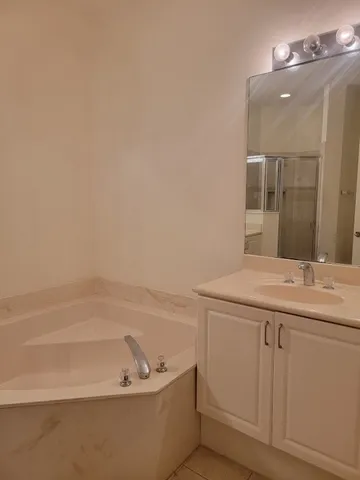 an empty room with a ceiling fan and a window