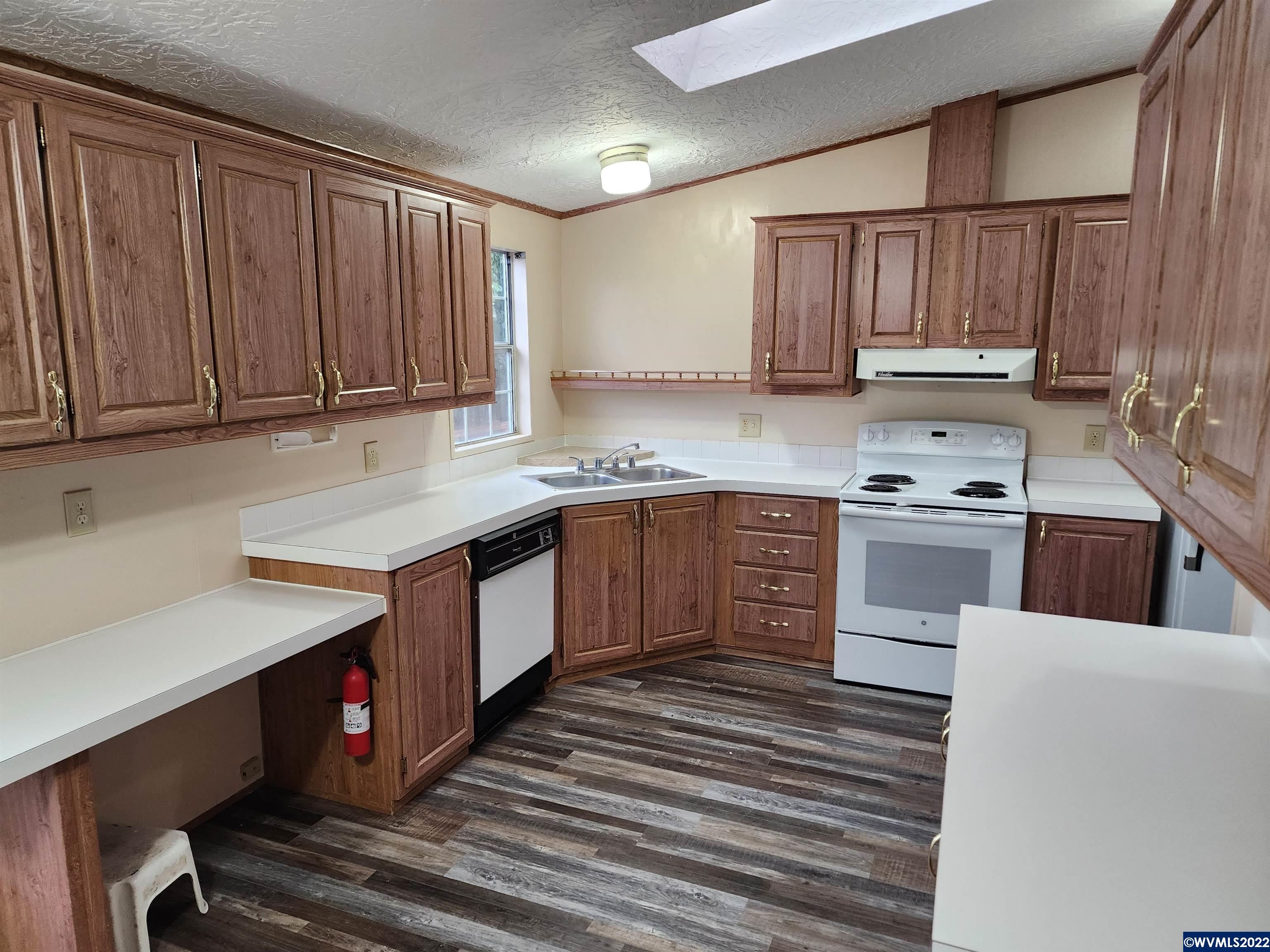 205 Boone Road Southeast, Unit 58 Salem, OR 97306 - Photo 8 of 19 a kitchen with stainless steel appliances granite countertop a stove a sink dishwasher and a refrigerator