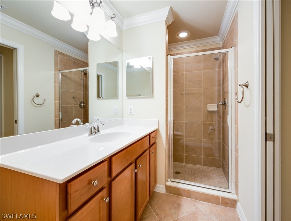 9727 Acqua Court, Unit 413 Naples, FL 34113 - Photo 14 of 35 a bathroom with a sink vanity granite shower and a mirror