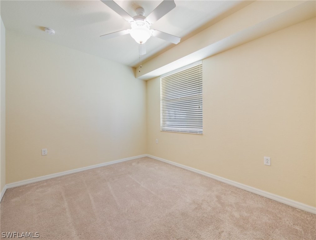 9727 Acqua Court, Unit 413 Naples, FL 34113 - Photo 17 of 35 an empty room with a window and a fan