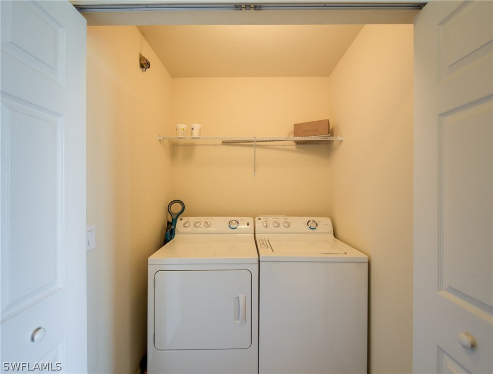 9727 Acqua Court, Unit 413 Naples, FL 34113 - Photo 19 of 35 a utility room with dryer and washer