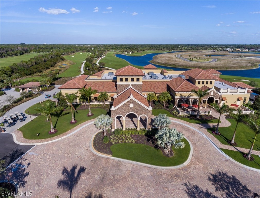 9727 Acqua Court, Unit 413 Naples, FL 34113 - Photo 20 of 35 a aerial view of a house with a garden and lake view