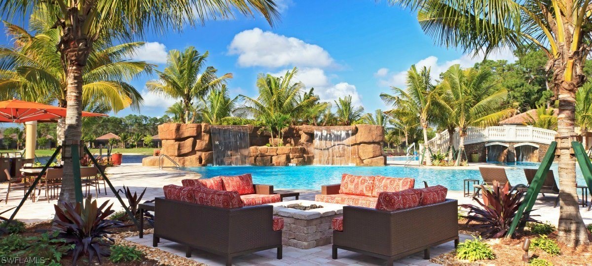 9727 Acqua Court, Unit 413 Naples, FL 34113 - Photo 31 of 35 a wooden bench sitting in front of a building