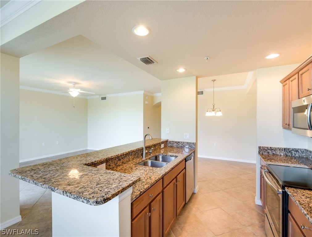 9727 Acqua Court, Unit 413 Naples, FL 34113 - Photo 4 of 35 a bathroom with a granite countertop sink and a mirror