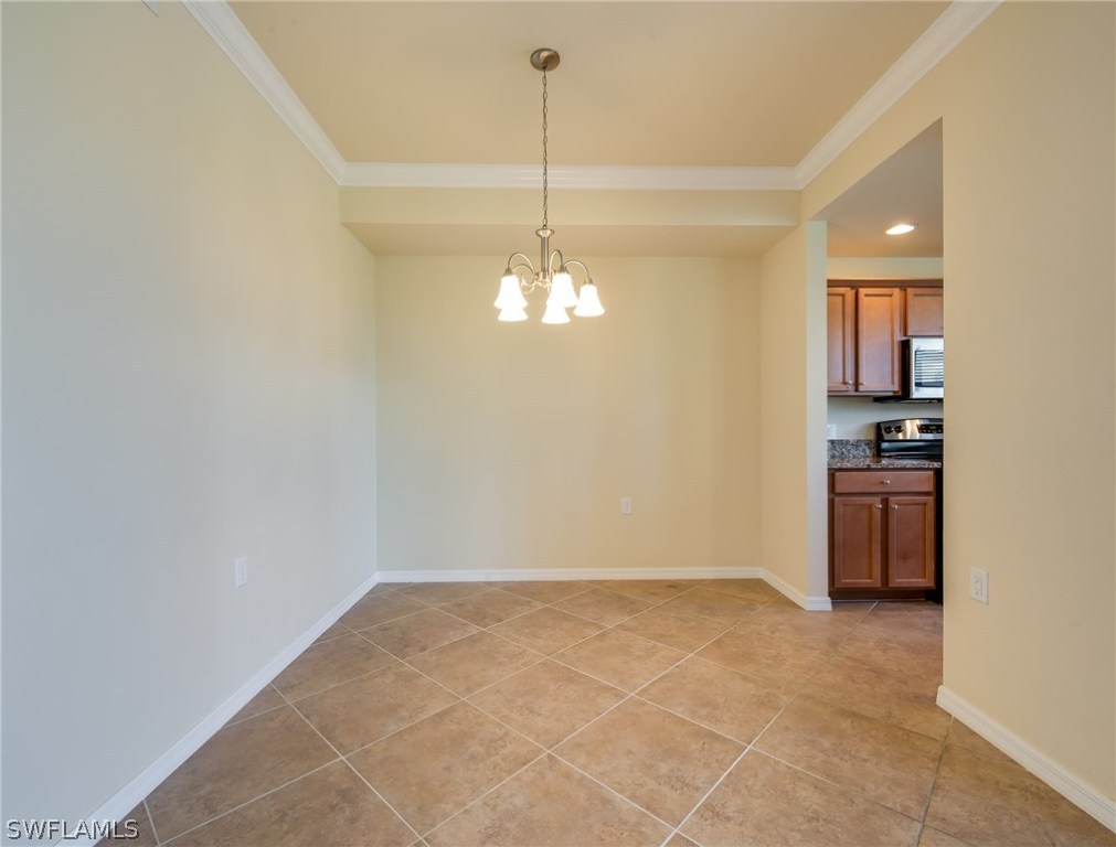 9727 Acqua Court, Unit 413 Naples, FL 34113 - Photo 8 of 35 a view of kitchen and chandelier